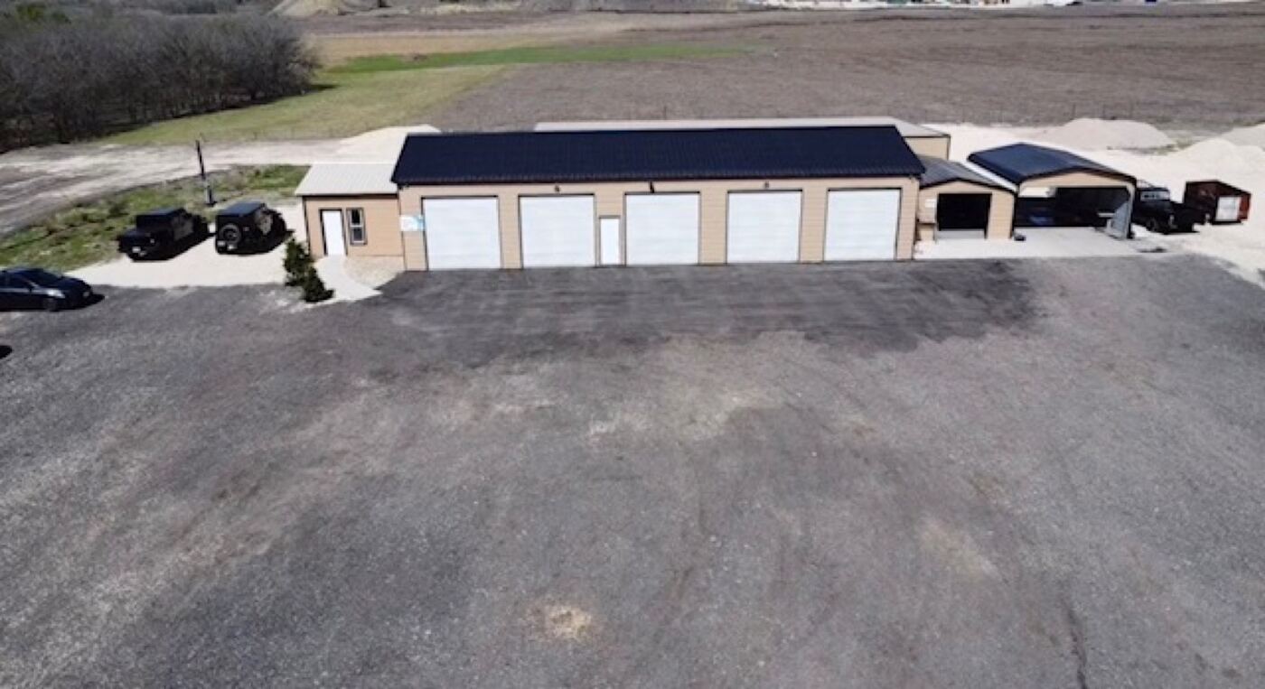 Aerial view of the Apex Auto Collision shop building and lot on Jacobson Rd in Manor, TX